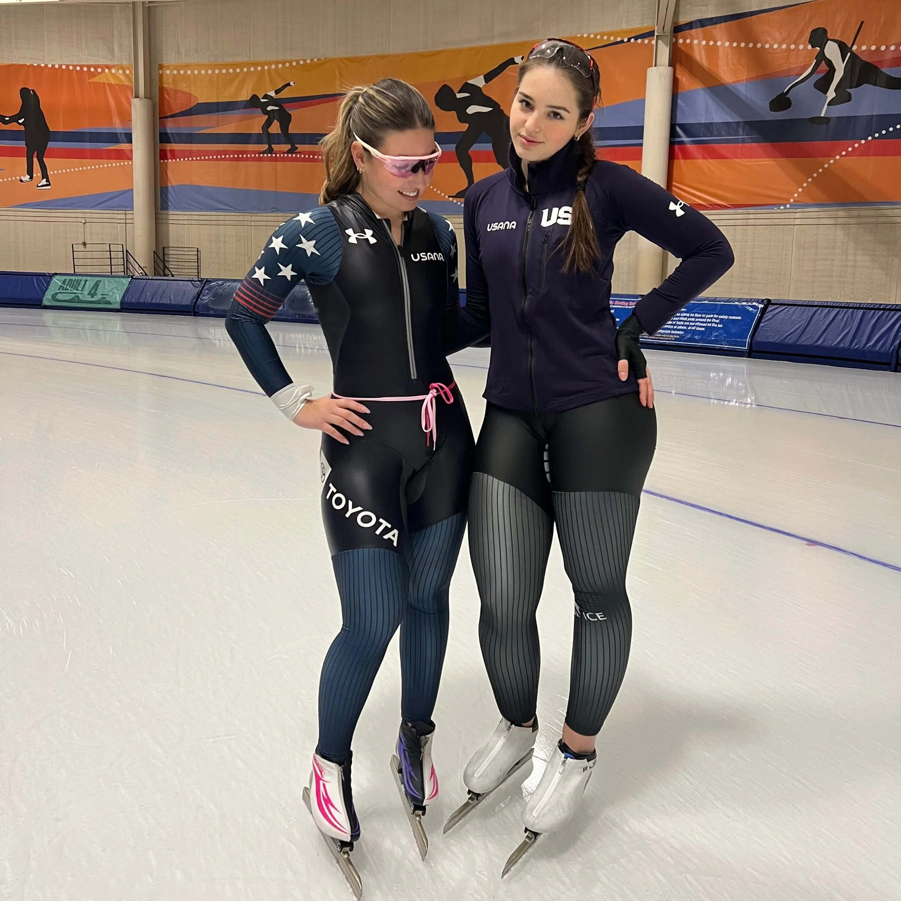 The duo standing on long track ice in team gear