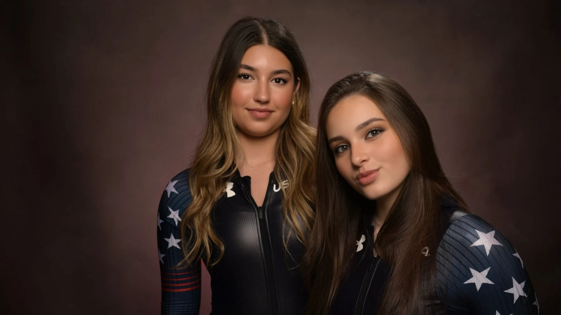 Studio portrait of the duo in USA suits